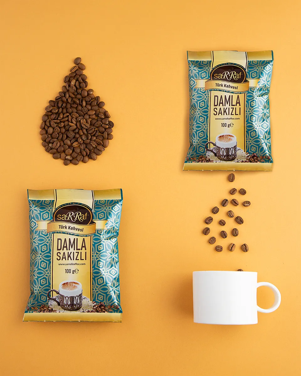 Two printed coffee pouches with coffee beans on yellow