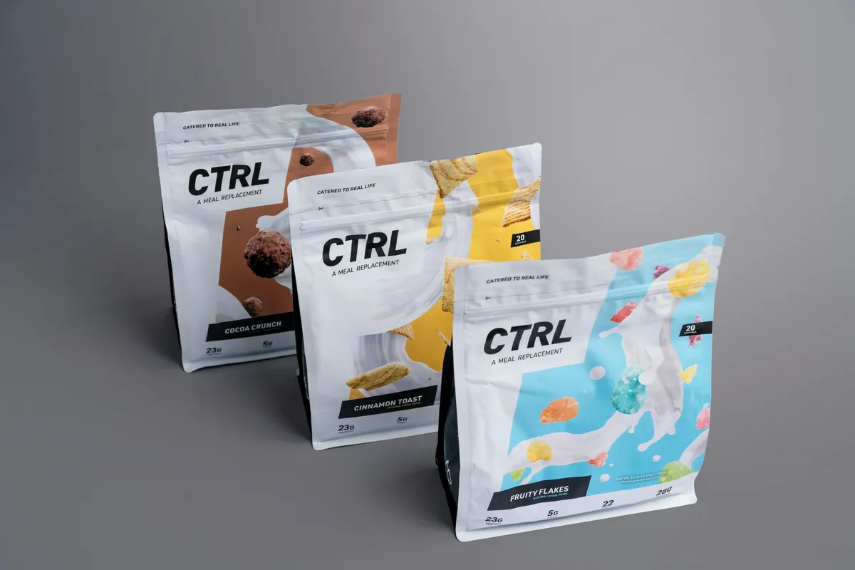Three flat-bottom pouches for a nutrition shake with bold product illustrations