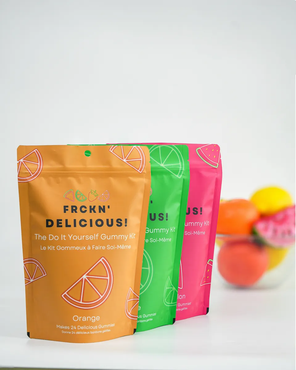Orange, green and pink printed stand-up pouches for a gummy kit