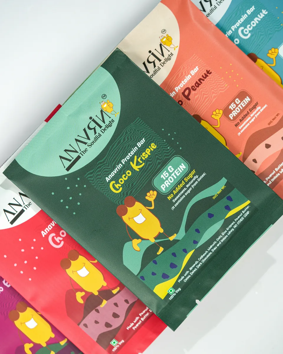 Colourful illustrated protein bar wrappers in printed flexible film, fanned out on white