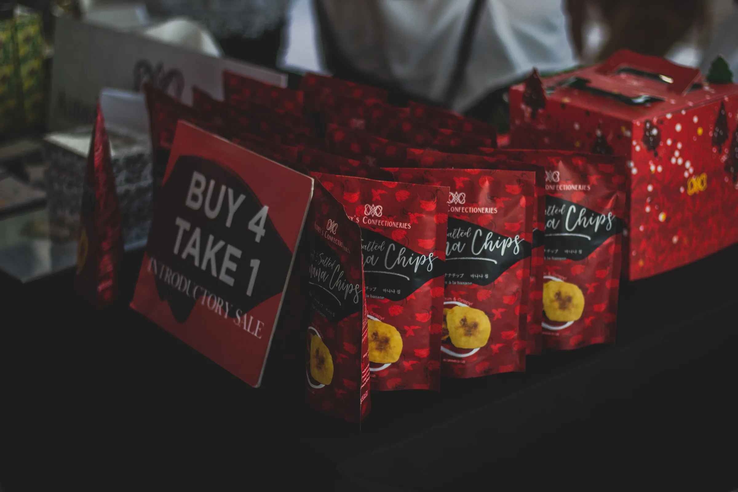 Red printed snack pouches on a market stall
