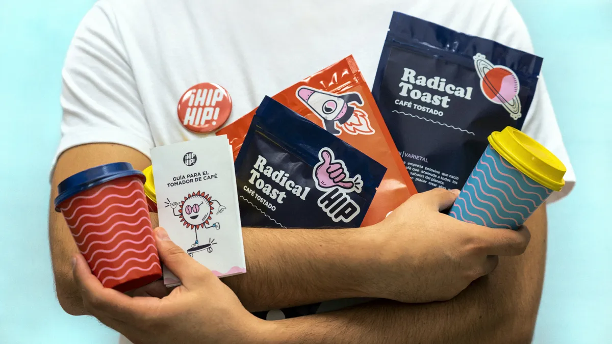 Coffee brand packaging range: printed pouches, takeaway cups and a coffee guide booklet