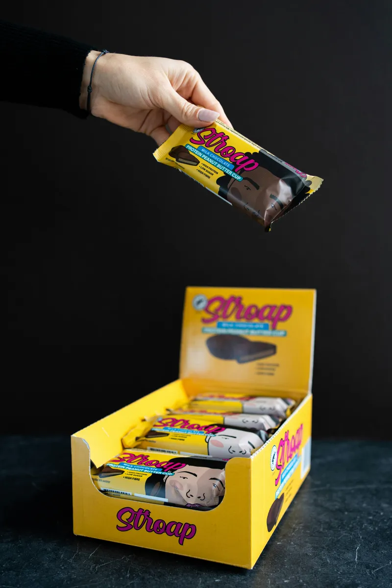 Yellow printed counter display box filled with wrapped chocolate bars