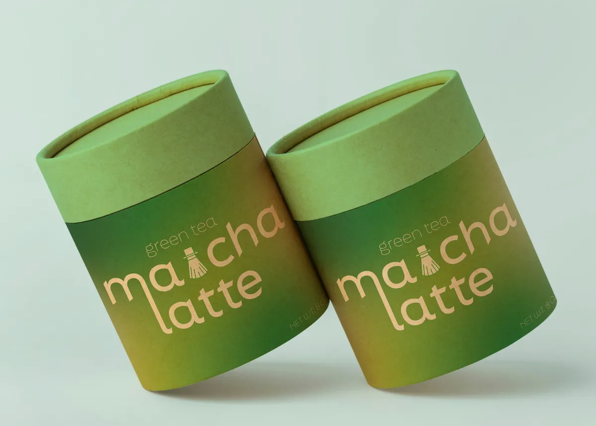 Two green paper tubes for matcha latte powder with a printed gradient wrap
